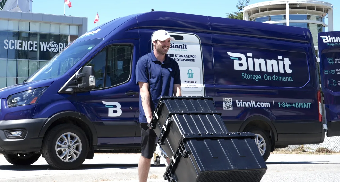 Binnit driver Nico with the branded van and the Binnit app outside Science World in Vancouver — smarter storage for home and business, from $30/month
